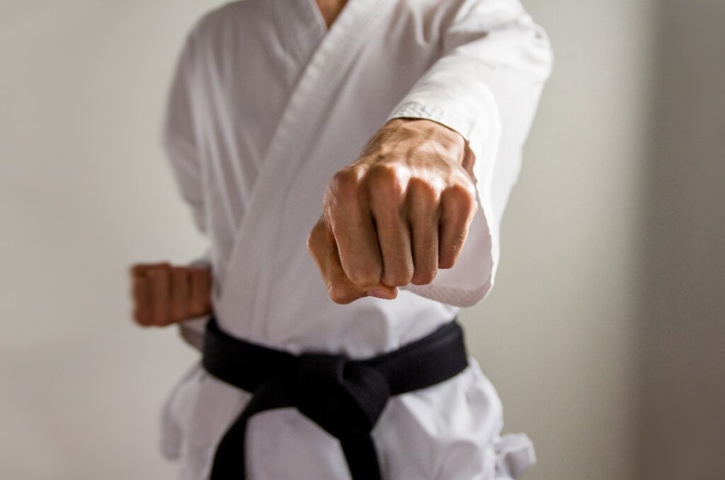 karate black belt demonstrating an oi-tsuki (forward punch)